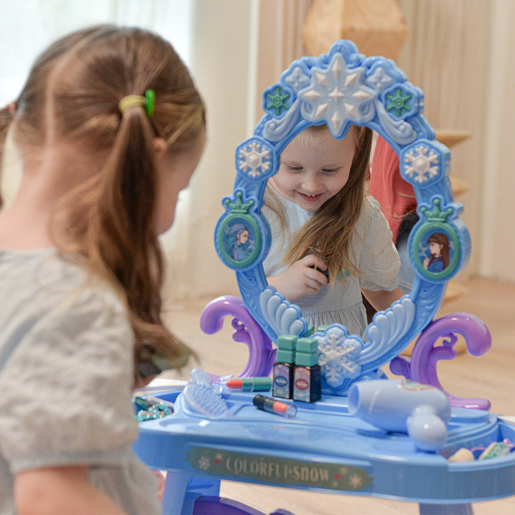 A girl using the little girls blue vanity set with lights & mirror