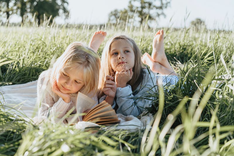 Girls reading and thinking outdoor