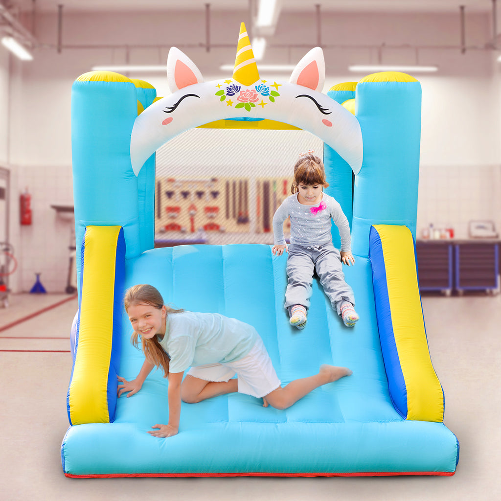 Two girls are using the slider of the Kids Inflatable Unicorn Themed Bounce House with Slide 
