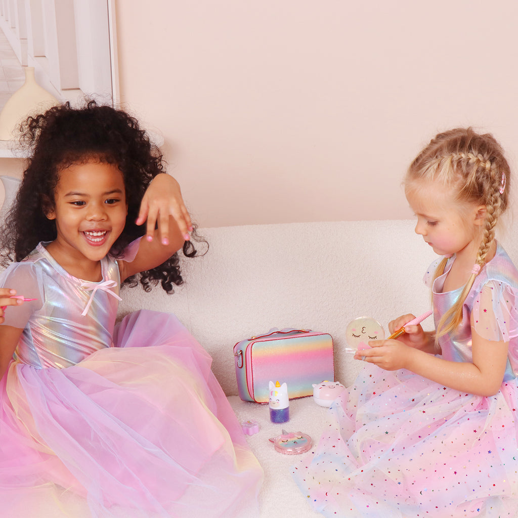 Two girls playing together with the unicorn makeup kit