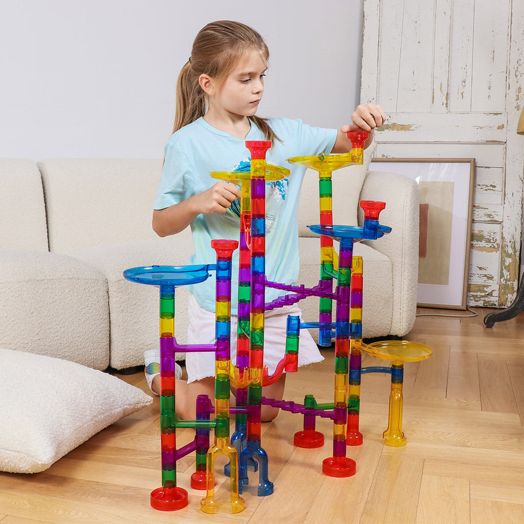 A girl playing with marble run toy